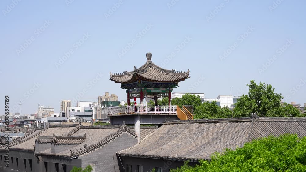 Pagoda stands strong on ancient Xian City Wall, bright sunny day