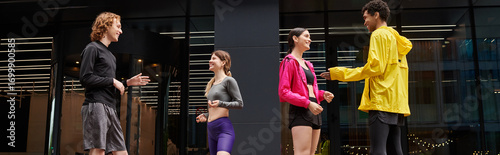 Slika na platnu Young athletes engage in a lively outdoor meet during a sunny day at the city pa