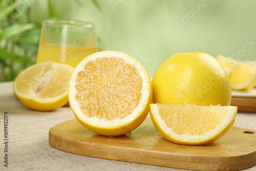 Fresh Golden Grapefruit Slices on Wooden Board with Juice Glass - Healthy Citrus Fruit
