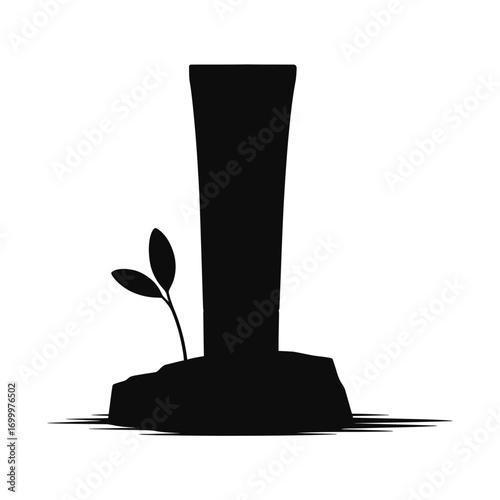 Silhouette of a tall plant growing beside a monumental structure