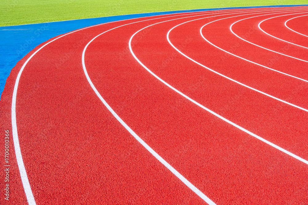 Fototapeta premium Empty running tracks at an outdoor athletics stadium featuring distinctive white lines and curves