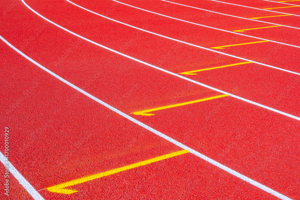 Fototapeta premium Empty running tracks at an outdoor athletics stadium featuring distinctive white lines and curves