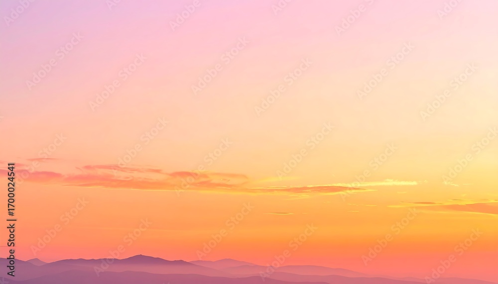 Obraz premium A serene, colorful sunset paints the sky in soft hues of orange, pink, and yellow, with hazy mountain ranges in the distance.