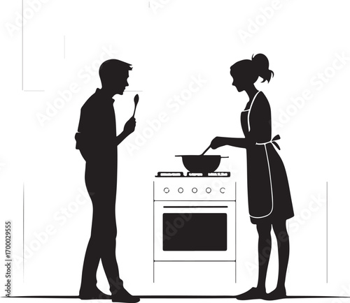 Silhouette of a man tasting food from a spoon while a woman cooks on a stove cooking kitchen