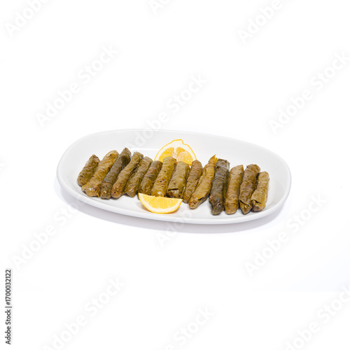 Stuffed vine leaves.Stuffed grape leaves with olive oil on a white background. Traditional Turkish cuisine delicacies. Delicious dolma (yaprak sarma). Horizontal view.
