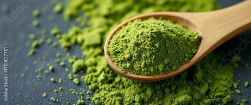 Wooden spoon filled with vibrant green spirulina powder 