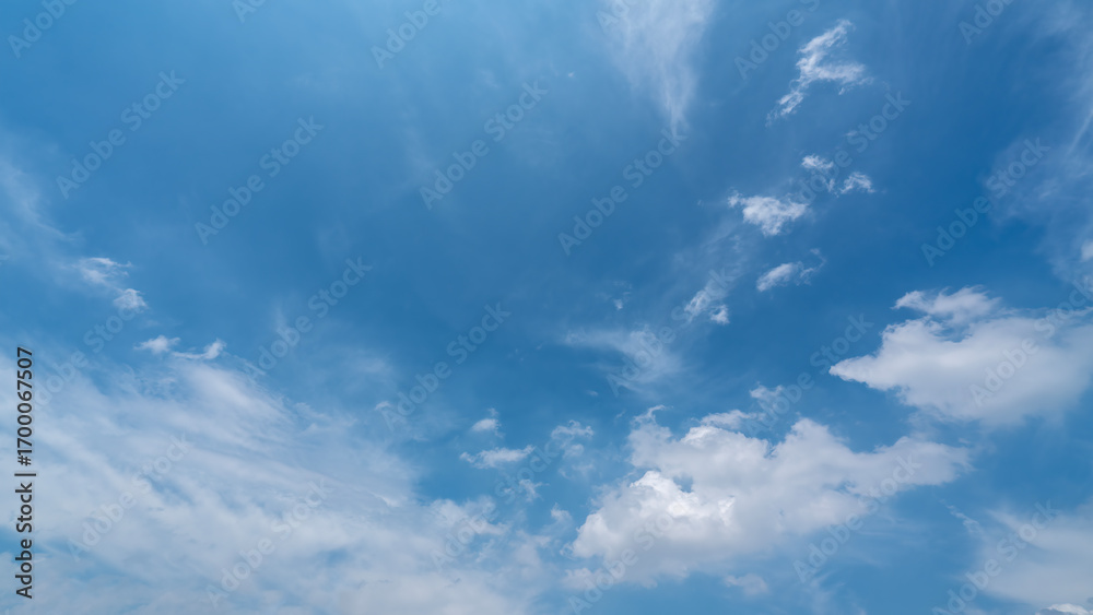 Obraz premium Blue Sky with Fluffy White Clouds on a Clear Day