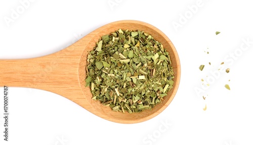 Dried herb in wooden spoon on white background
