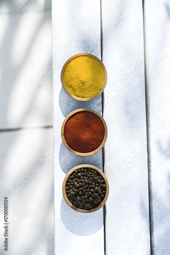 Turmeric Paprika Peppercorns Overhead View in Wooden Bowls on Rustic Wood