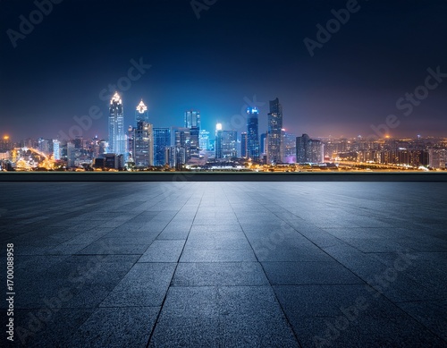 dark concrete floor with night city skyline in background illuminated by city lights