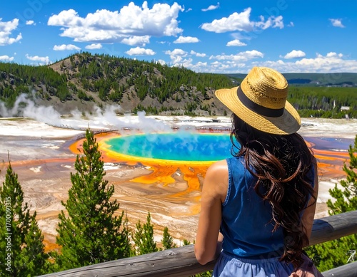 Female tourist enjoying panoramic view of geyser basin in yellowstone park