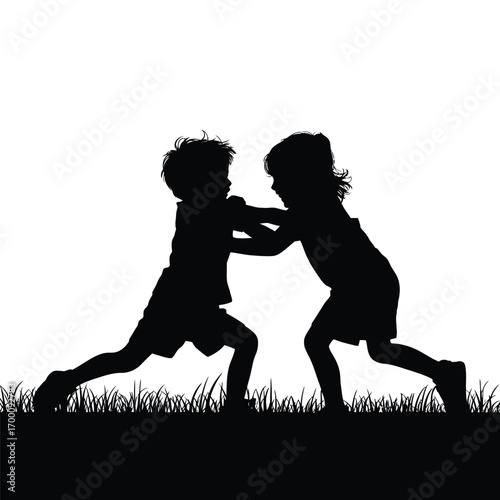 Silhouette of Two Children Playing or Fighting in a Grassy Field