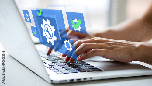 Hands typing on a laptop computer with digital interface and gears overlay