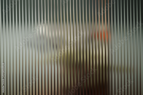 Abstract vertical ribbed glass texture with blurred colorful shapes visible through the surface