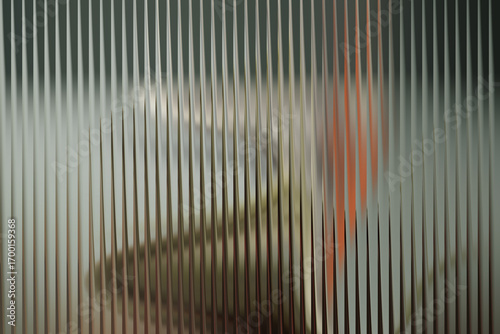 Abstract vertical ribbed glass texture with blurred colorful shapes and muted background tones