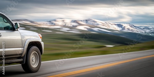 Silver suv driving on scenic mountain highway in summer