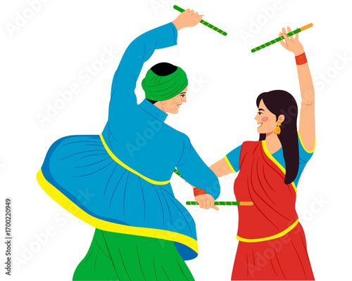 couple playing dandiya at garba night celebrating durga puja and navratri festival 