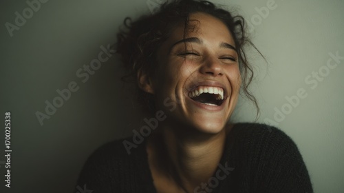 Joyful abandon: Portrait of a woman expressing uninhibited laughter