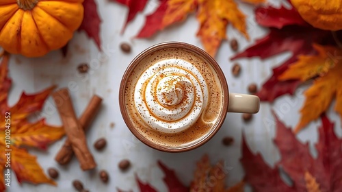 A cozy autumn flat lay with a pumpkin spice latte topped with a cinnamon roll, surrounded by colorful fall leaves. A warm and inviting top-down view of a seasonal hot beverage