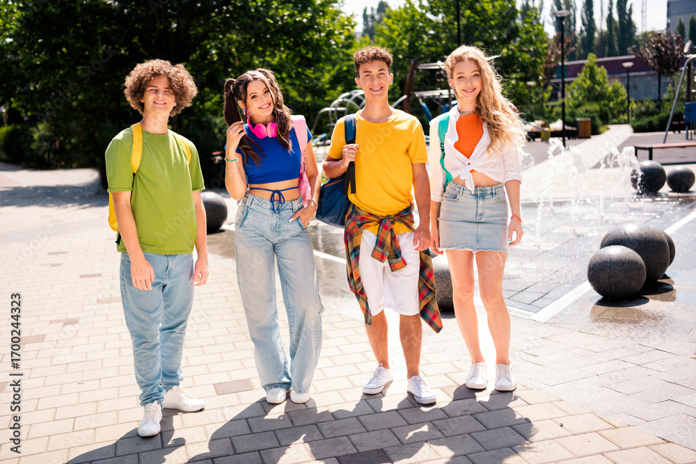 Fototapeta premium Group of young friends enjoying an outing in a city park on a sunny day showcasing togetherness and cheerful energy