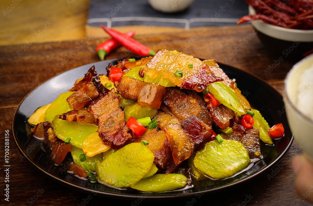 Fototapeta premium Stir-Fried Lettuce with Bacon and Vegetables on Black Plate