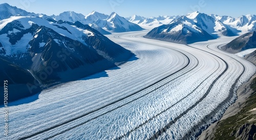 Wallpaper Mural Expansive aerial view of a massive winding glacier with dramatic snow capped mountains under a clear blue sky Torontodigital.ca