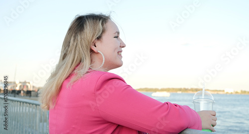 Quadro su tela plus size woman in the street looking at the river on the embankment