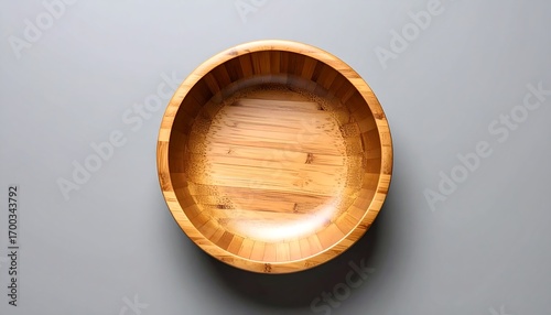 Empty round bamboo bowl on gray background