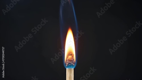 Close-up of a match being struck, slowly catching fire with dramatic sparks and vivid flames. Slow motion with cinematic atmosphere. 5 seconds.
