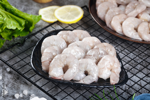 Fresh Raw Jumbo Shrimp in Cast Iron Pan with Lemon and Lettuce - Premium Seafood Cooking Ingredients