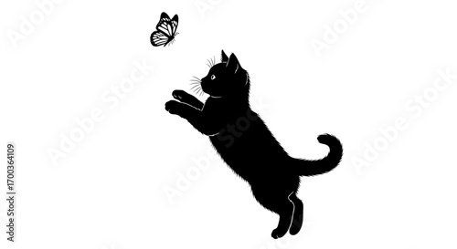 Black cat playfully leaps in the air to catch a butterfly.