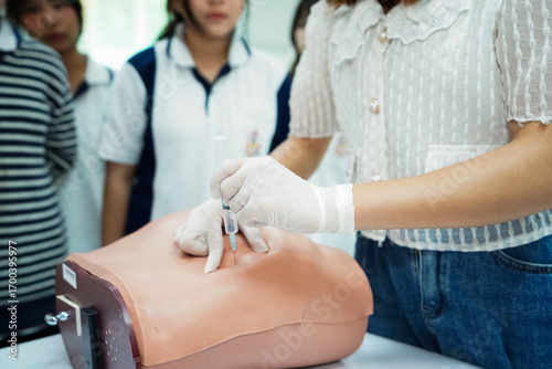 Nursing Student Practicing Injection with Training Model