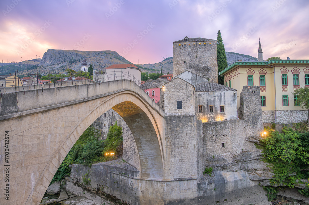 Obraz premium Morning light illuminates the Old Bridge in Mostar, highlighting its architectural beauty and charm