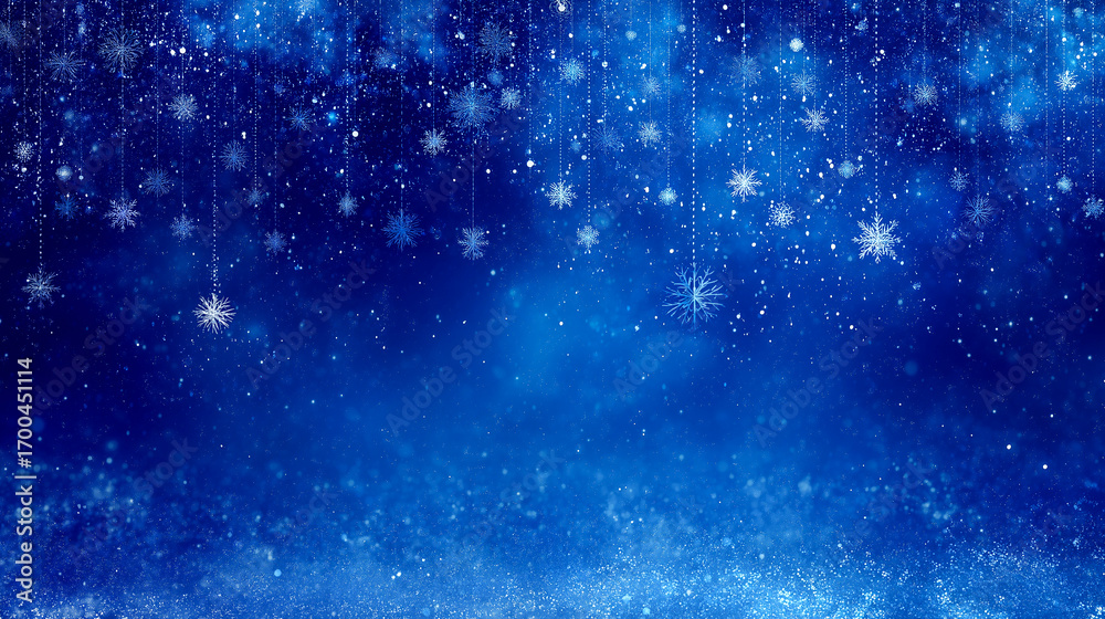 Obraz premium 吊り下がる雪の結晶ときらめきの粒が降るブルー背景（冬のイメージ）