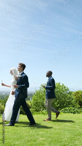 Vertical video: Diverse wedding party entering lawn sipping champagne inviting guest to toast