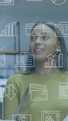 Animation of computer application icons over diverse coworkers discussing reports in office