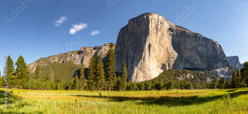 This summer panorama features the rock climbing vertical granite monolith El Capitan, captured from Yosemite Valley in Yosemite National Park, California.