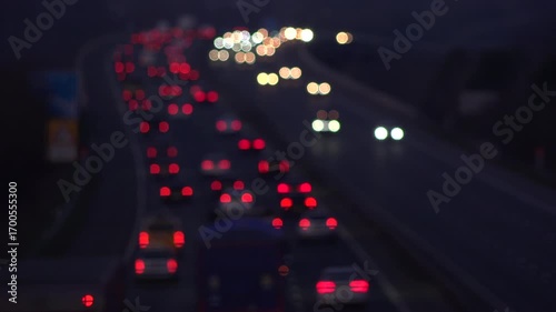 Aerial evening shot of transport moving along freeway motorway with lights in the dark. Manchester rush hour with cars and trucks UK 4K 