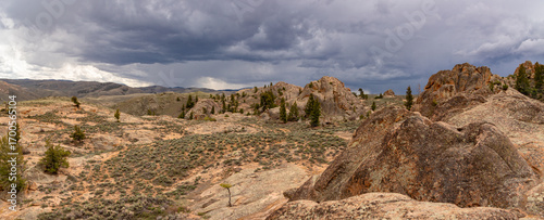 This panorama features dark storm clouds approaching Hartman Rocks Recreation Area in Gunnison, Colorado.