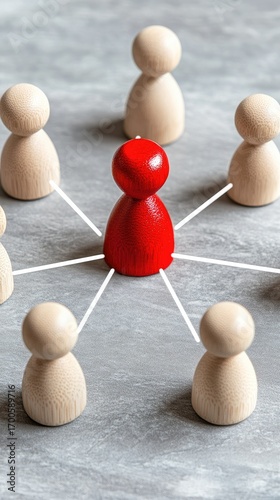 A red wooden figure stands at the core of a network, encircled by white figures against a blue background, illustrating the concept of leadership and collaboration