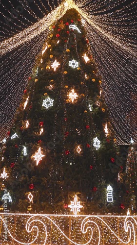 Amazing Christmas tree with illumination in the night city, winter season.