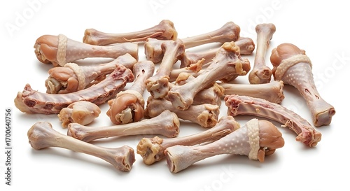 A collection of chicken bones forming a disorganized pile against a stark white backdrop