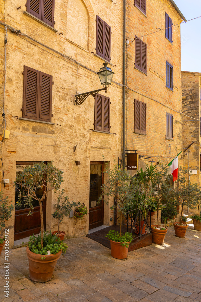 Fototapeta premium Charming Hotel in Tuscany with Potted Plants and Italian Flag