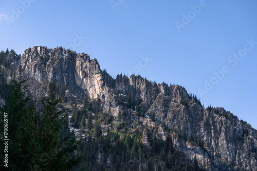 Fototapeta Naklejka Na Ścianę i Meble -  snow covered mountains tatry poland with clouds around and big pine trees