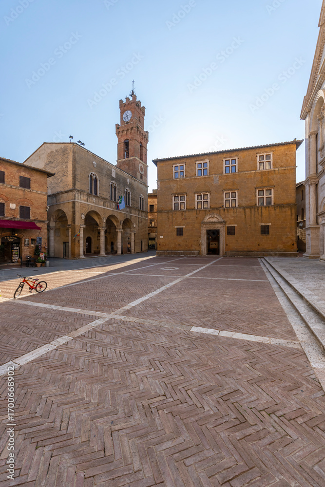 Naklejka premium Piazza Pio II featuring Palazzo Piccolomini and the Clock Tower in Pienza, Tuscany, Italy