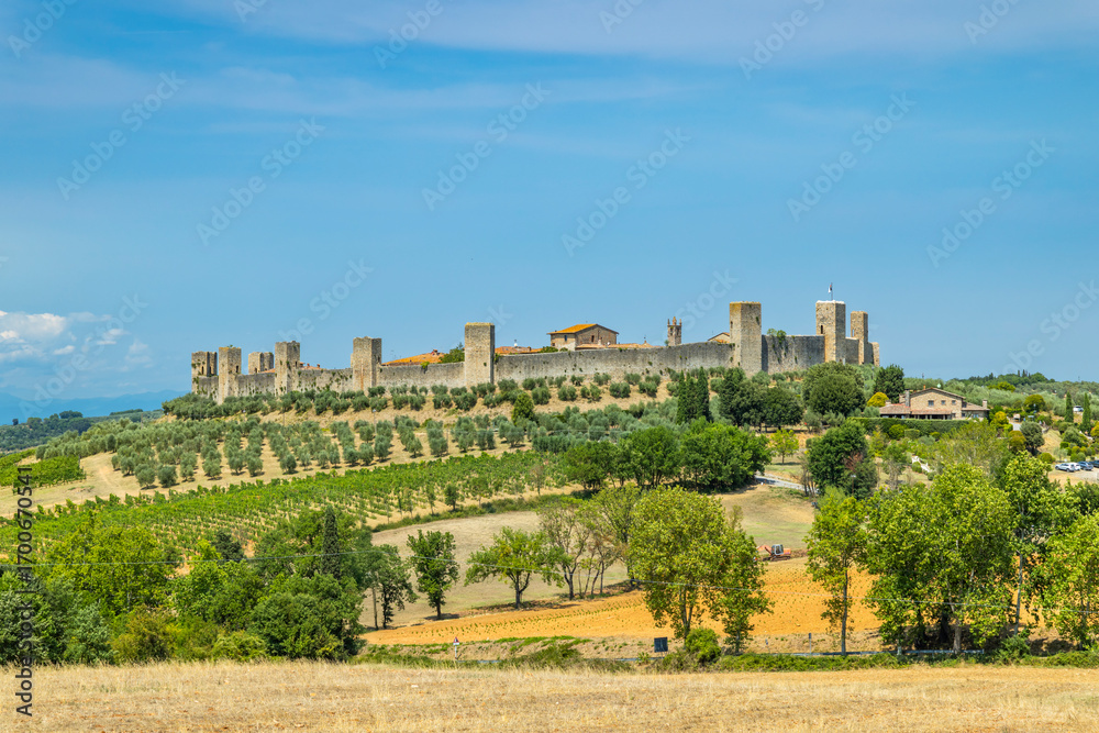 Obraz premium Monteriggioni medieval walls rising above Tuscan landscape in summer