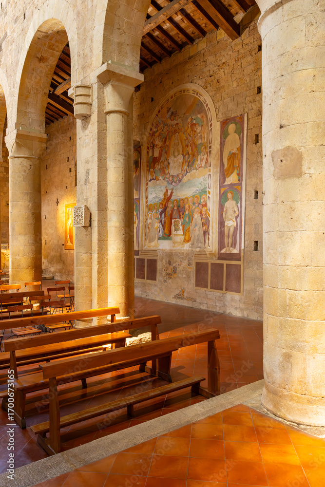Fototapeta premium Interior of Church of Santa Maria Assunta showcasing frescoes and wooden pews in Monteriggioni, Italy