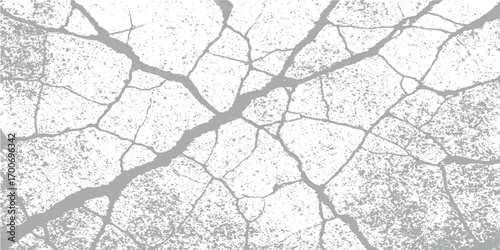 Cracked and textured brown earth surface with a background of old rusty metal and tree branches