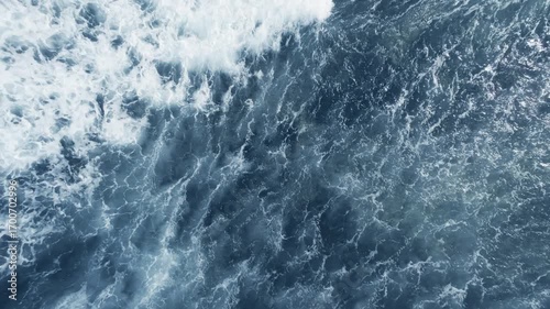 Top view of ocean waves at daytime on sunlight. Wide angle lens shot. Power of ocean concept