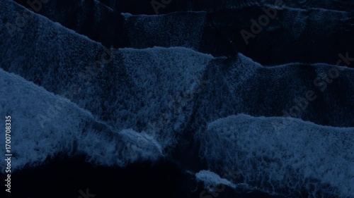 Drone view on splashing waves in ocean at night. Power of ocean concept